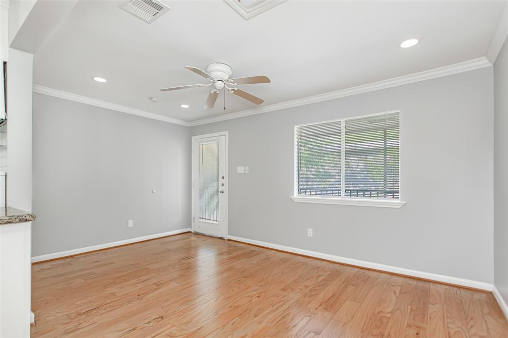 4931 Junius Street, Unit 8 Dallas, TX 75214 - Photo 7 of 31 an empty room with wooden floor and windows