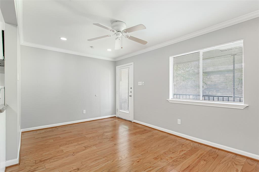 4931 Junius Street, Unit 8 Dallas, TX 75214 - Photo 8 of 31 a view of an empty room with wooden floor and a window