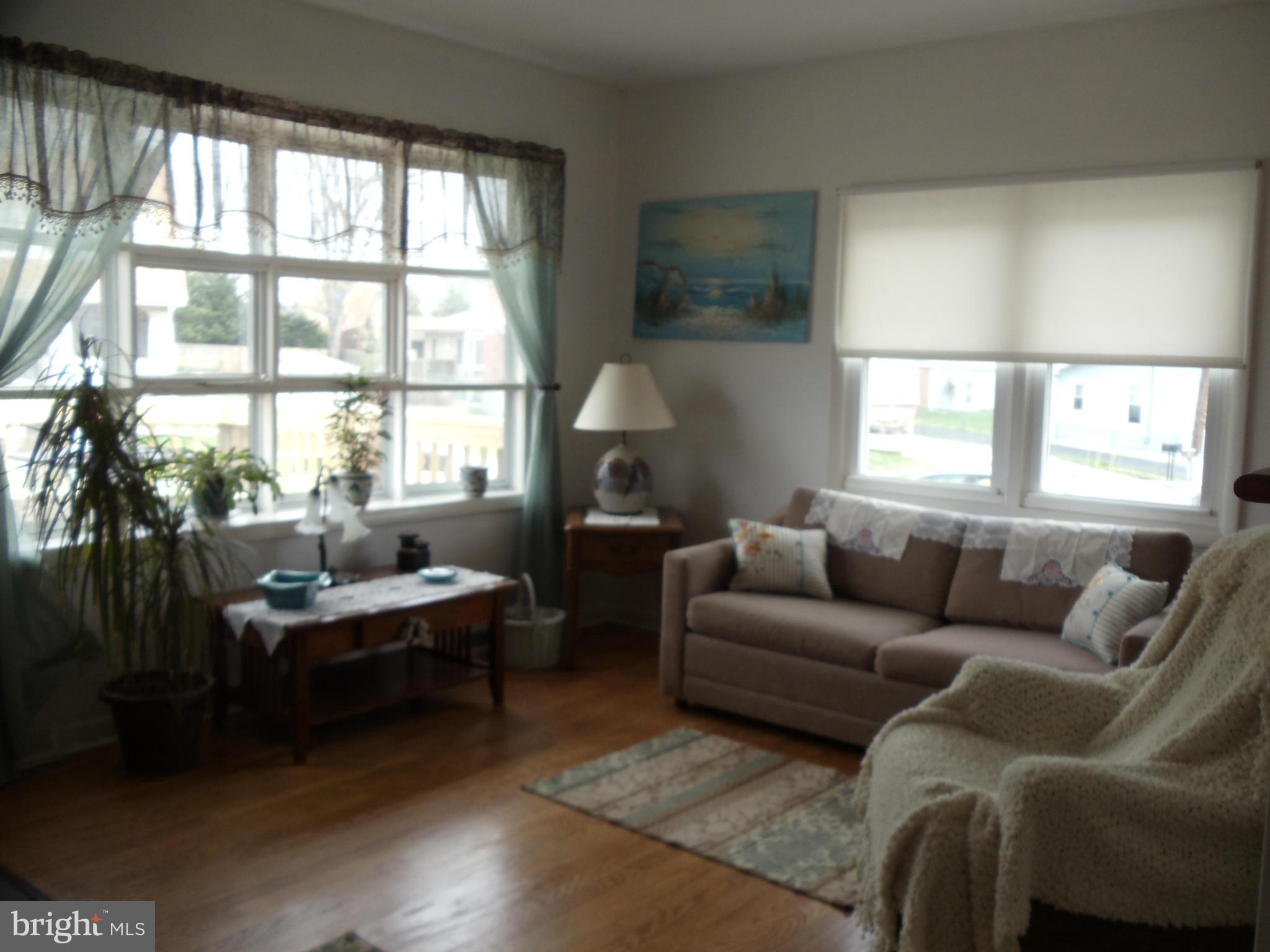 8222 Highpoint Road Clearwater Beach, MD 21226 - Photo 2 of 22 Living Rm offers lots of sunshine & hardwoods!