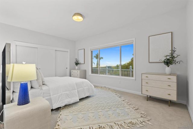 a spacious bedroom with a bed and a large window