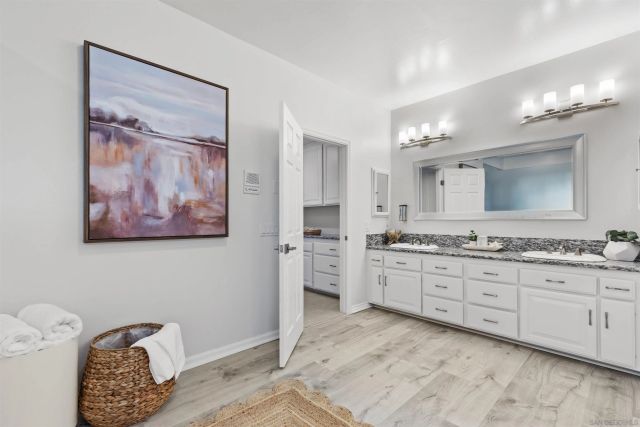a view of a room with furniture and wooden floor