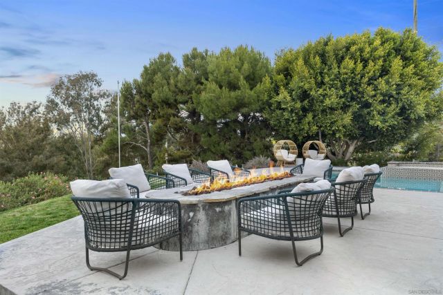 a dining room with wooden floor a glass table and chairs