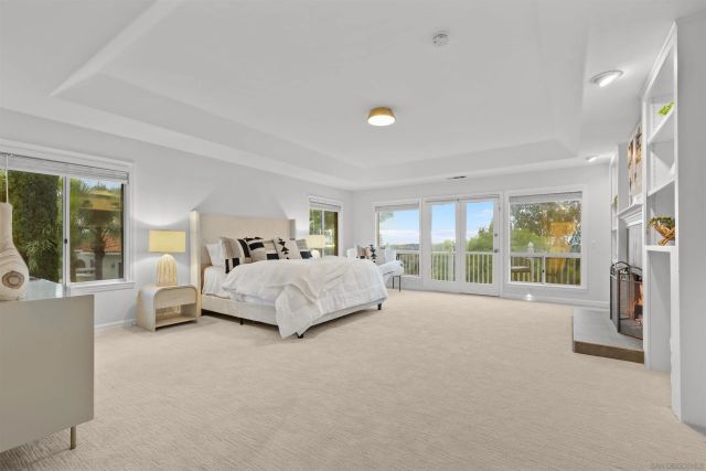 a spacious bedroom with a large bed and a large window