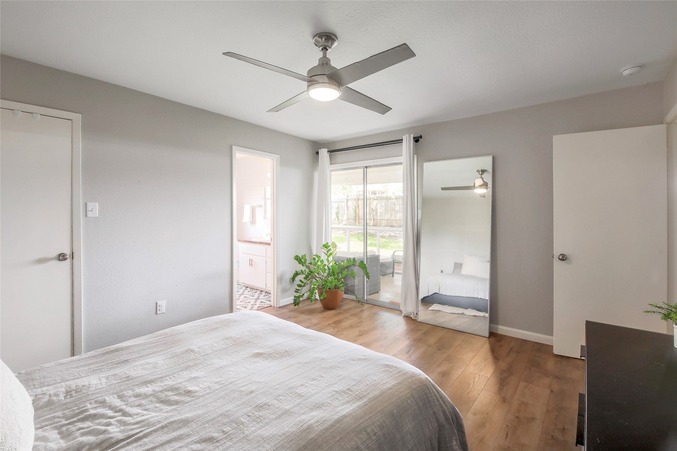 11118 Wandering Way Austin, TX 78754 - Photo 21 of 35 Unit B primary bedroom with ensuite, slider to outdoor patio