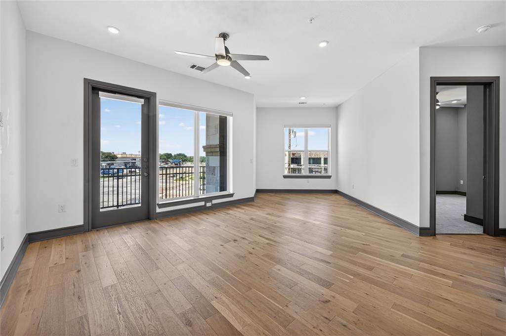 2700 Old Denton Road, Unit 2259 Carrollton, TX 75007 - Photo 16 of 39 a view of an empty room with a window and wooden floor