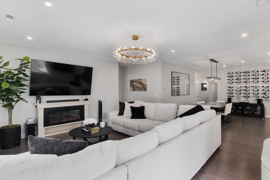 9 Iris Lane Bellingham, MA 02019 - Photo 13 of 34 a living room with furniture a flat screen tv and a fireplace