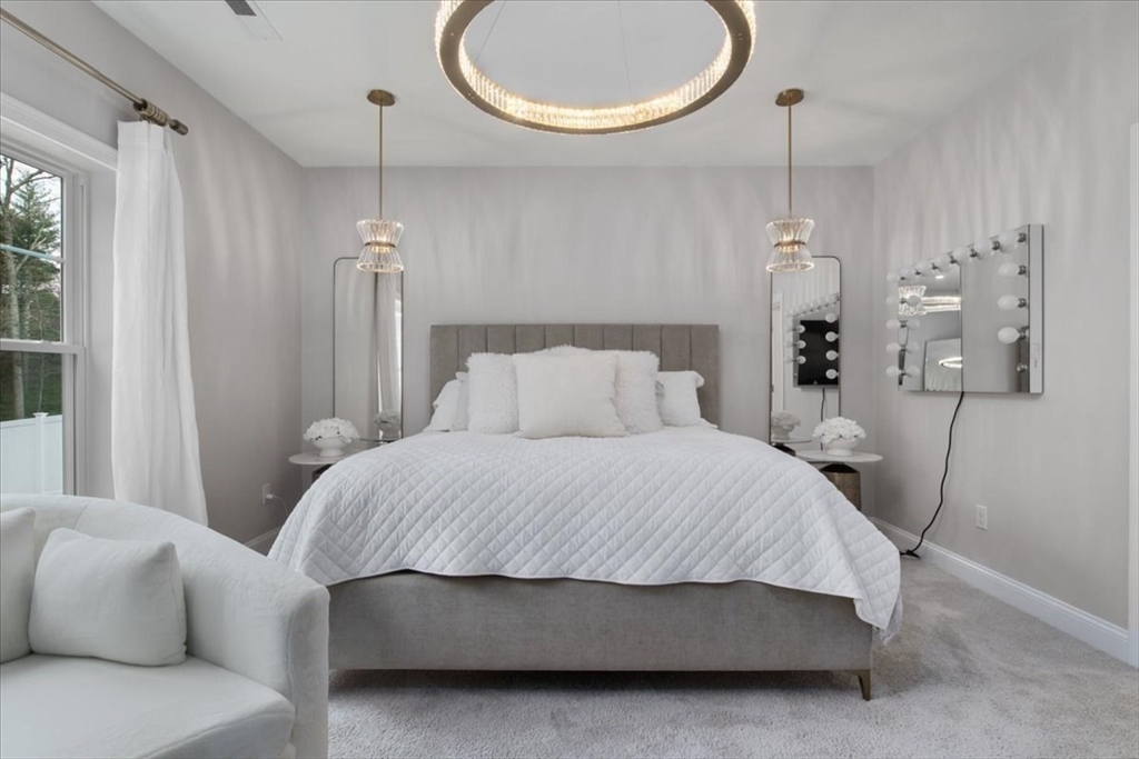 9 Iris Lane Bellingham, MA 02019 - Photo 16 of 34 a bedroom with a bed and a chandelier