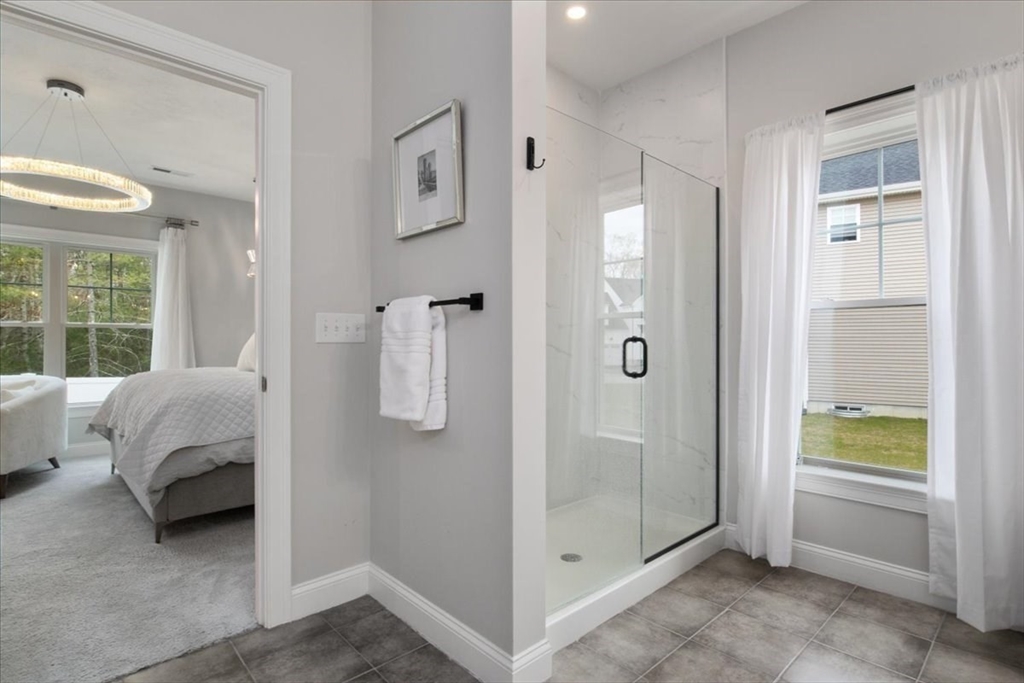 9 Iris Lane Bellingham, MA 02019 - Photo 18 of 34 a en suite bathroom with a granite countertop sink and a shower