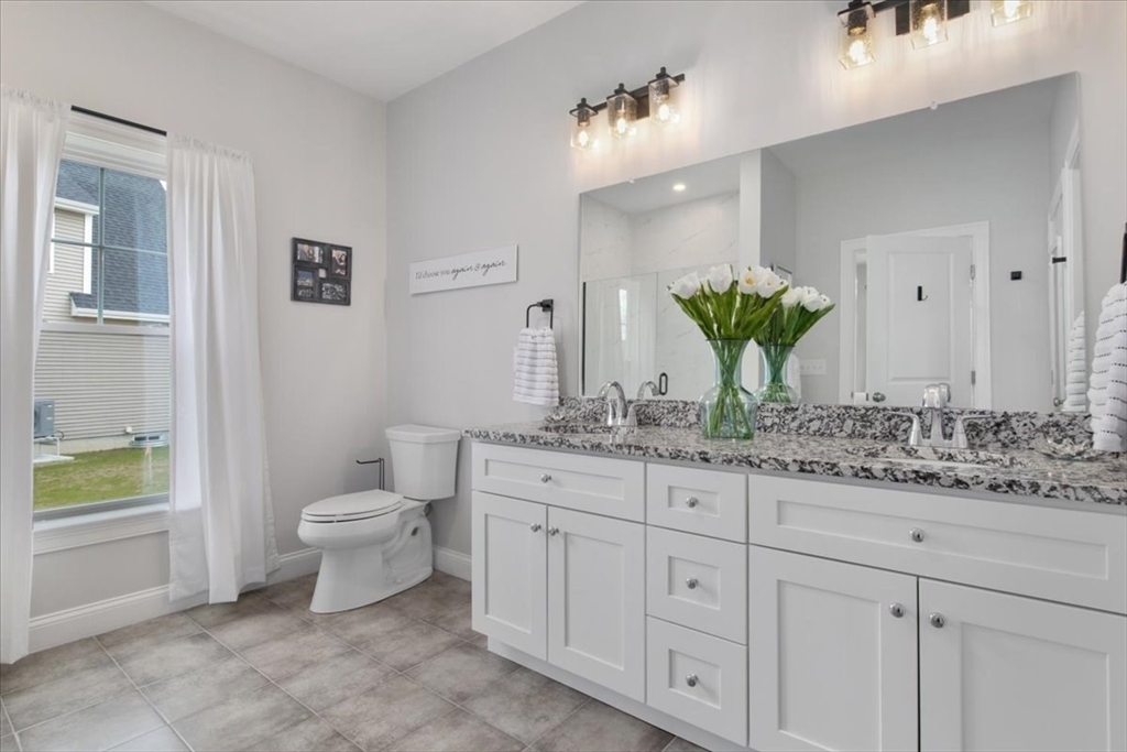 9 Iris Lane Bellingham, MA 02019 - Photo 19 of 34 a bathroom with a granite countertop toilet sink and mirror