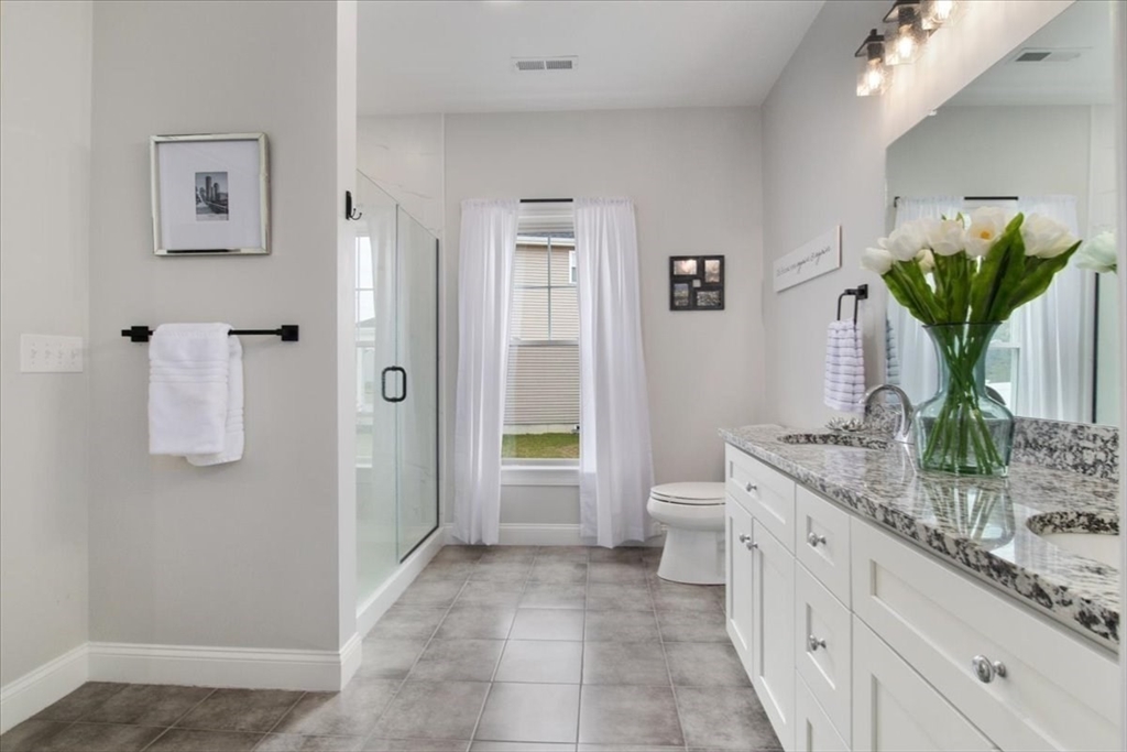 9 Iris Lane Bellingham, MA 02019 - Photo 20 of 34 a spacious bathroom with a granite countertop sink a toilet and a shower