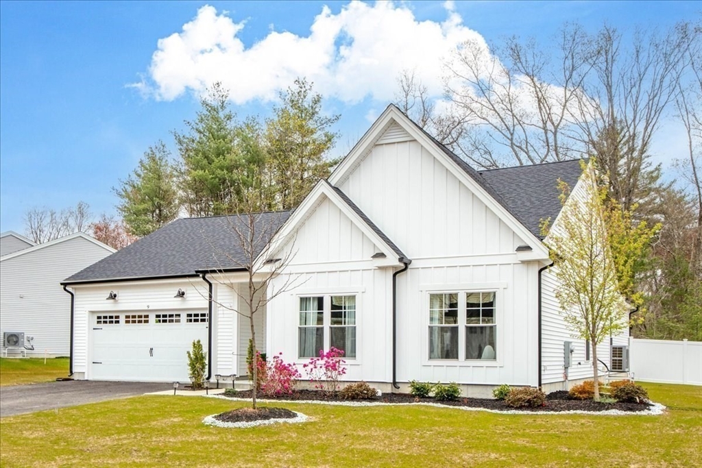 9 Iris Lane Bellingham, MA 02019 - Photo 2 of 34 a view of a white house with a large pool and large trees