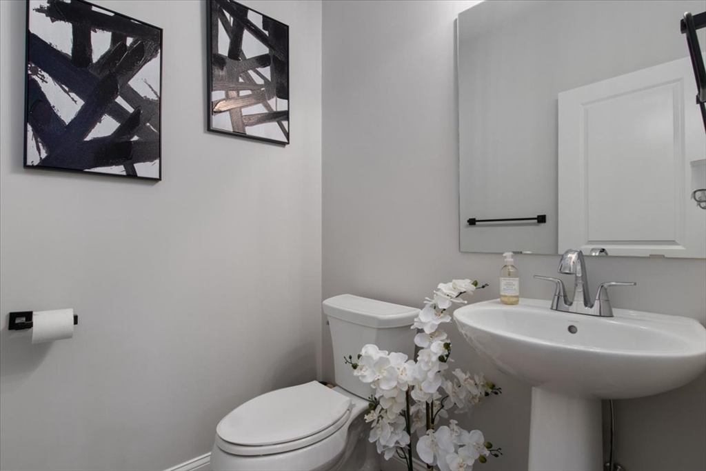 9 Iris Lane Bellingham, MA 02019 - Photo 23 of 34 a bathroom with a toilet sink and mirror