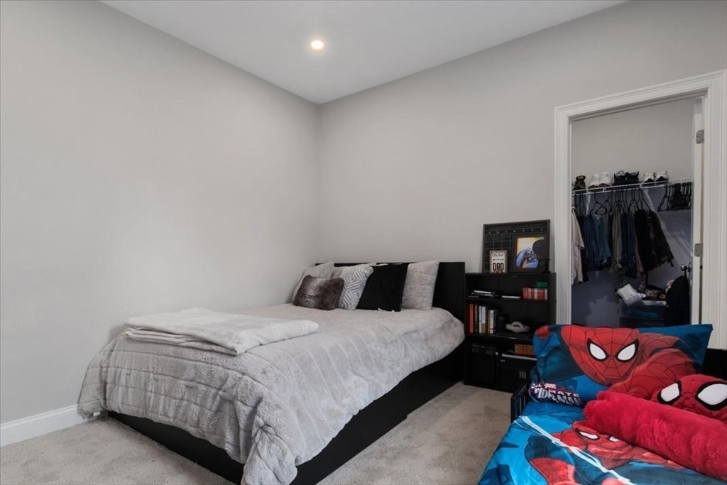 9 Iris Lane Bellingham, MA 02019 - Photo 24 of 34 a bedroom with a bed and a mirror