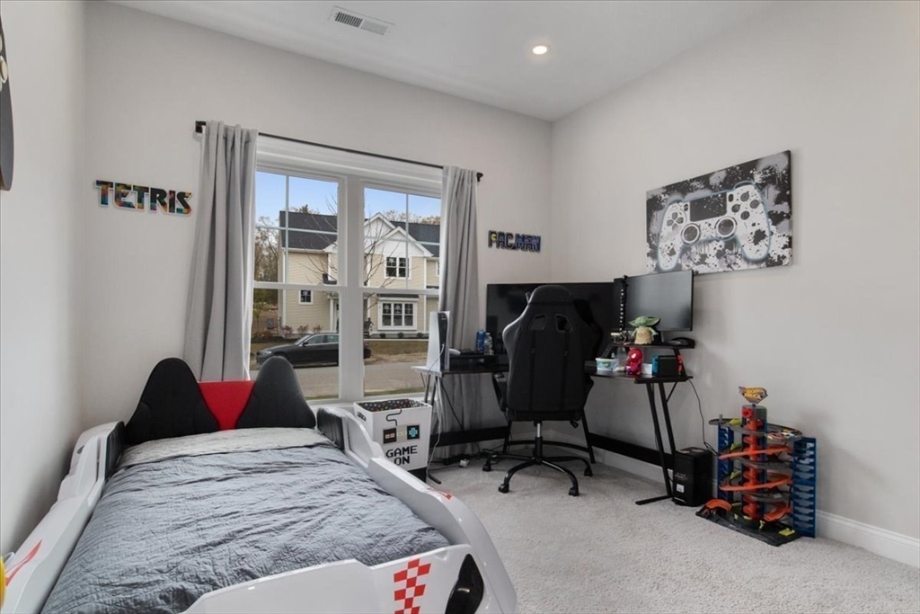 9 Iris Lane Bellingham, MA 02019 - Photo 25 of 34 a bedroom that has a bed and a chair in it