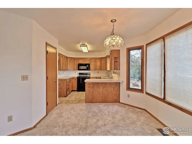 a open kitchen with stainless steel appliances granite countertop a stove oven and a refrigerator with granite countertops