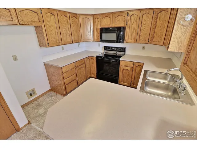 a kitchen with stainless steel appliances a stove sink microwave and cabinets