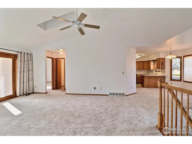 a view of a livingroom with a ceiling fan and window