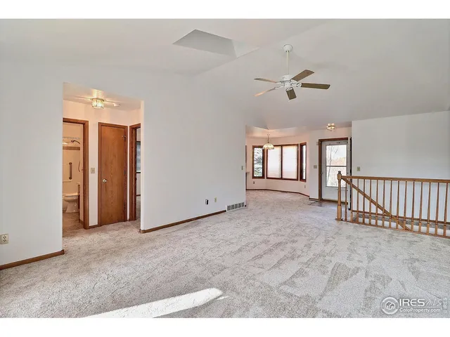 a view of an empty room with a kitchen