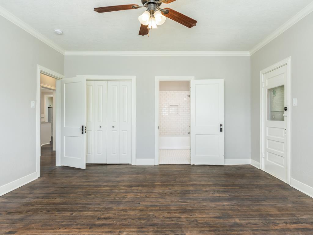 4528 Avenue R 1/2 Galveston, TX 77551 - Photo 19 of 22 a view of a livingroom with a ceiling fan window and wooden floor