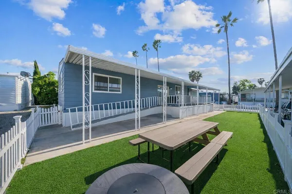 a view of a house with backyard swimming pool and sitting area
