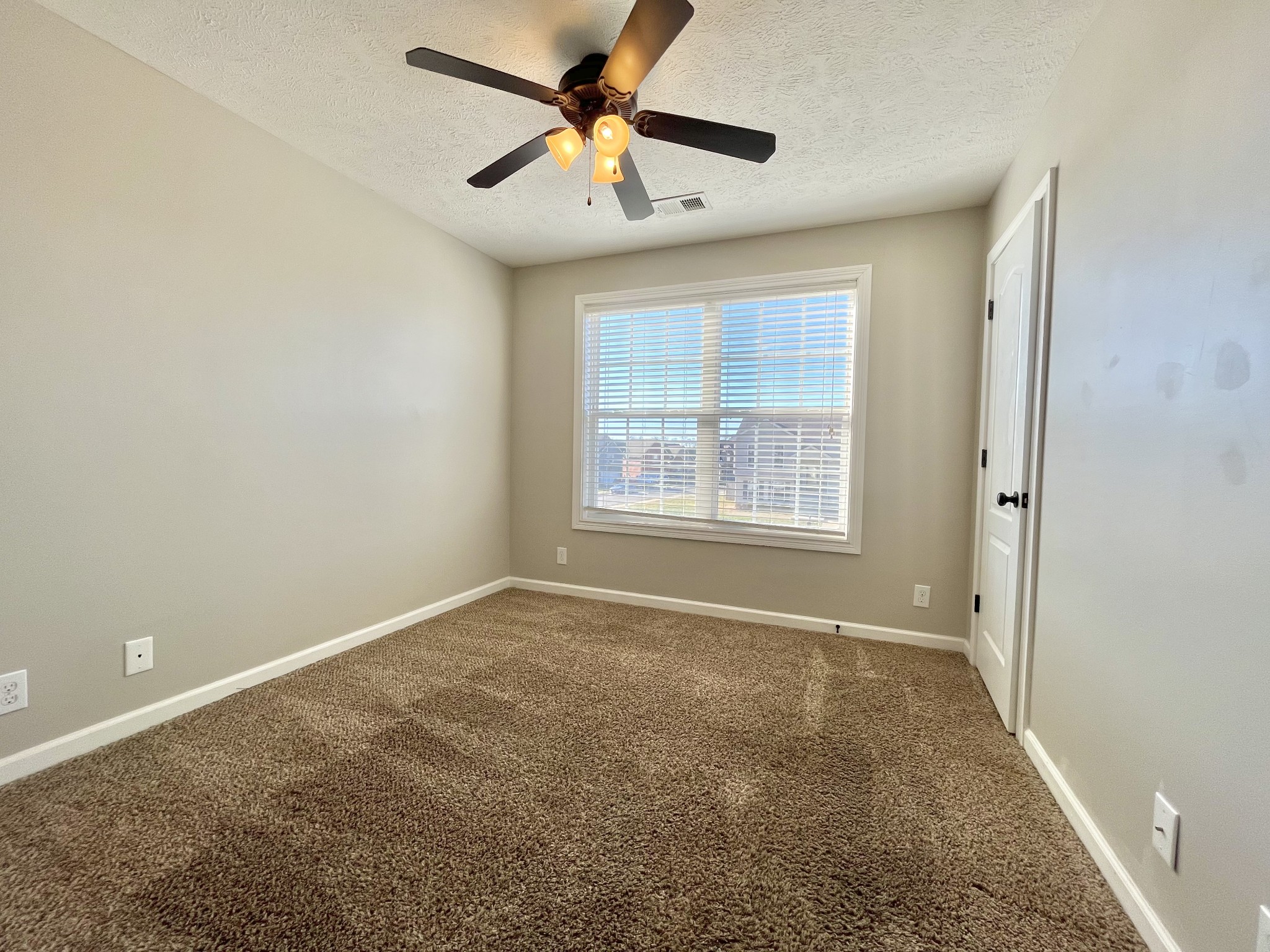 3773 Suiter Road Clarksville, TN 37040 - Photo 11 of 25 an empty room with a window and a fan