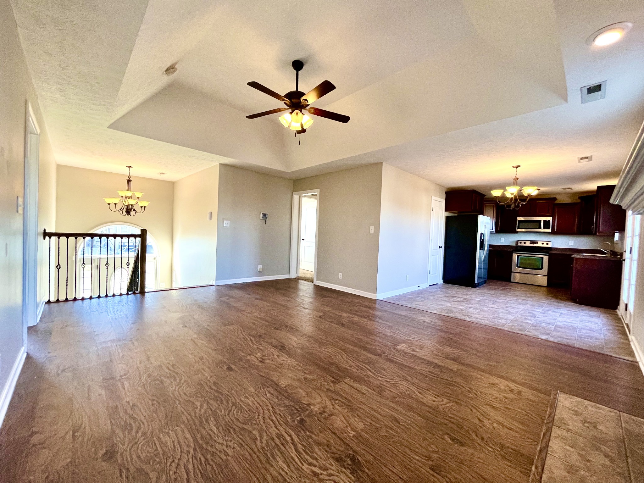 3773 Suiter Road Clarksville, TN 37040 - Photo 3 of 25 a view of a big room with wooden floor and a kitchen