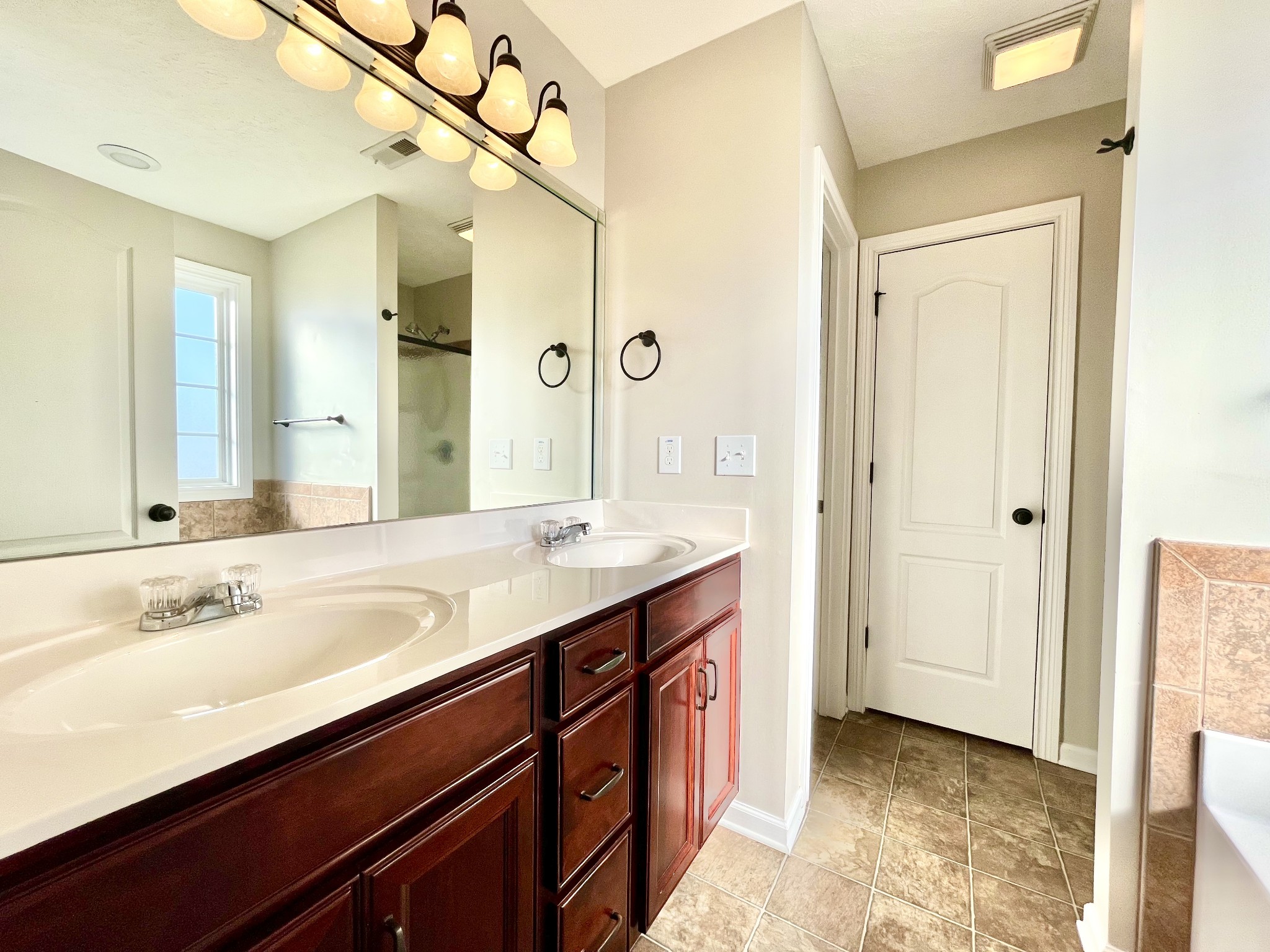 3773 Suiter Road Clarksville, TN 37040 - Photo 8 of 25 a spacious bathroom with a shower sink and mirror