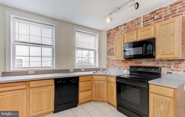 a kitchen with stainless steel appliances granite countertop a sink and a microwave