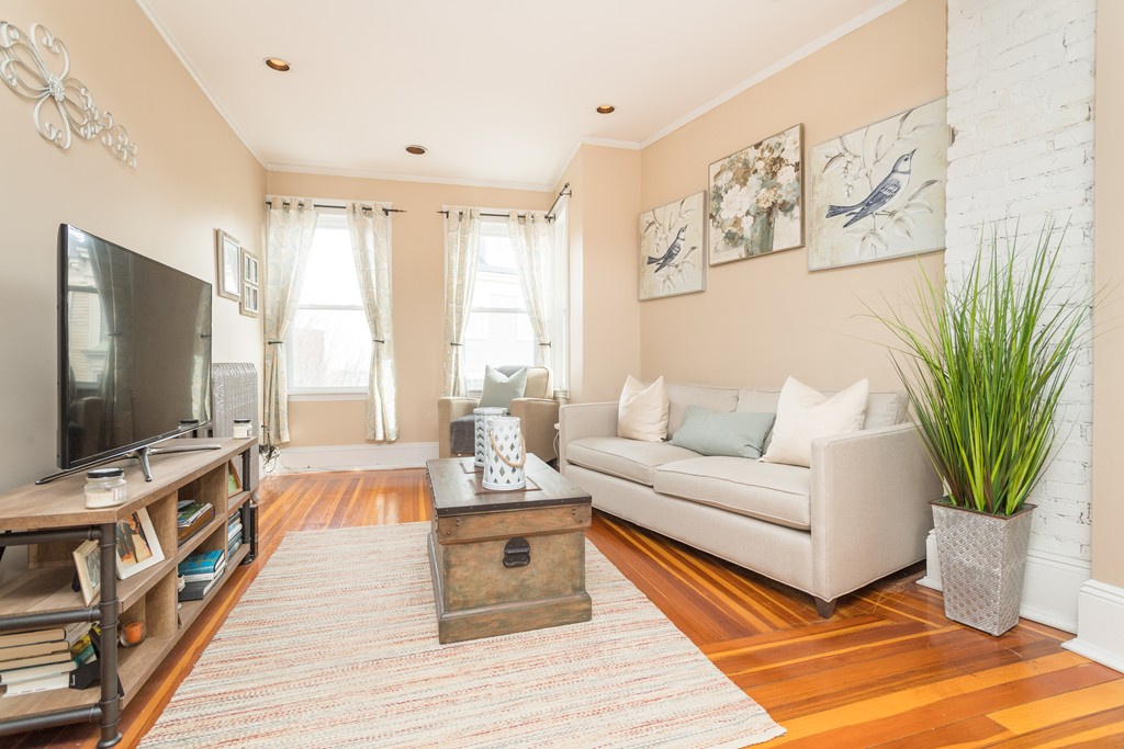 64 Chestnut Street, Unit 3 Boston, MA 02129 - Photo 1 of 9 a living room with furniture and a flat screen tv