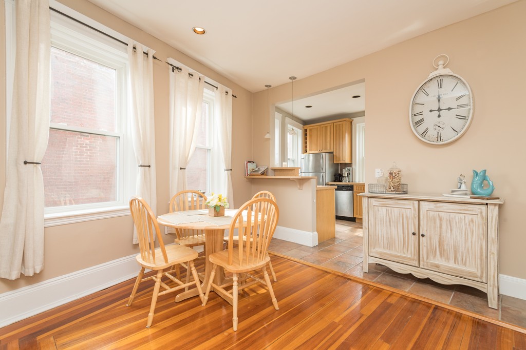 64 Chestnut Street, Unit 3 Boston, MA 02129 - Photo 3 of 9 a dining room with wooden floor a glass table and chairs