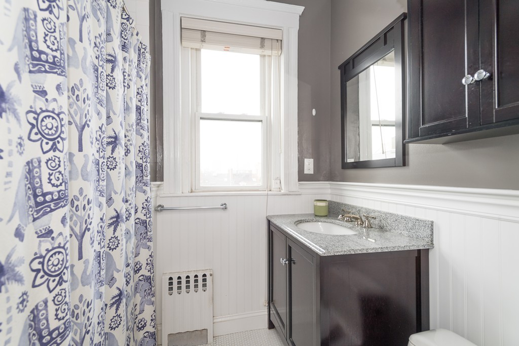 64 Chestnut Street, Unit 3 Boston, MA 02129 - Photo 5 of 9 a bathroom with a sink and a mirror