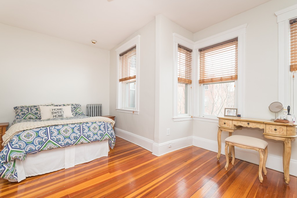 64 Chestnut Street, Unit 3 Boston, MA 02129 - Photo 7 of 9 a bedroom with a bed and a table in it