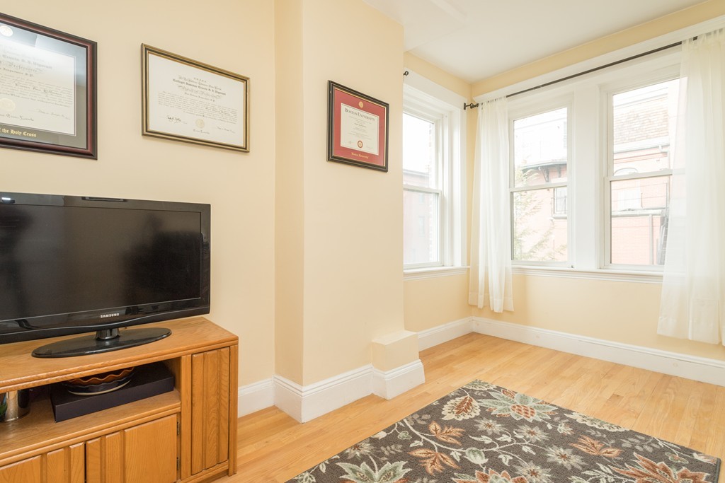 64 Chestnut Street, Unit 3 Boston, MA 02129 - Photo 9 of 9 a living room with a flat screen tv and a window
