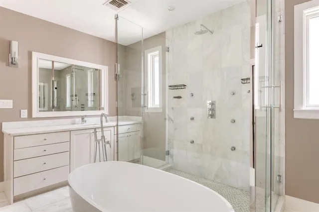 a spacious bathroom with a shower sink and mirror