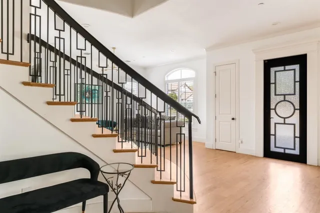 a view of entryway with wooden floor and stairs