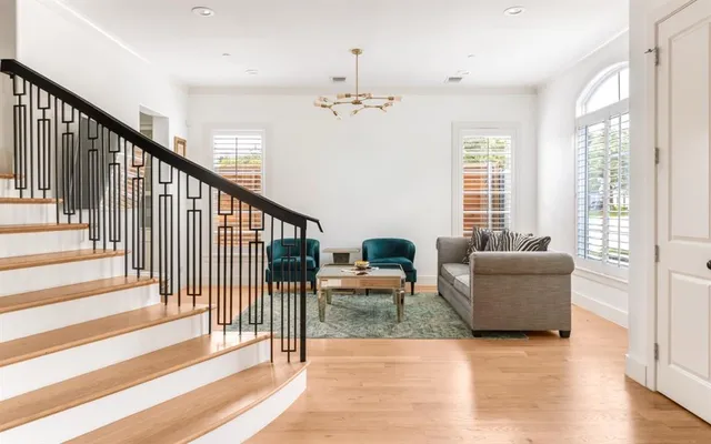 a view of a livingroom with furniture wooden floor and windows