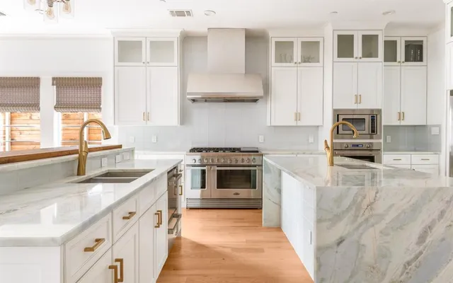 a kitchen with stainless steel appliances granite countertop a stove and a sink