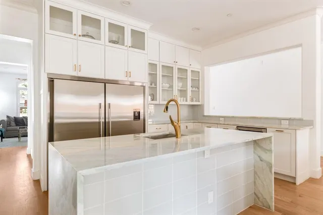 a kitchen with a refrigerator a sink and a window