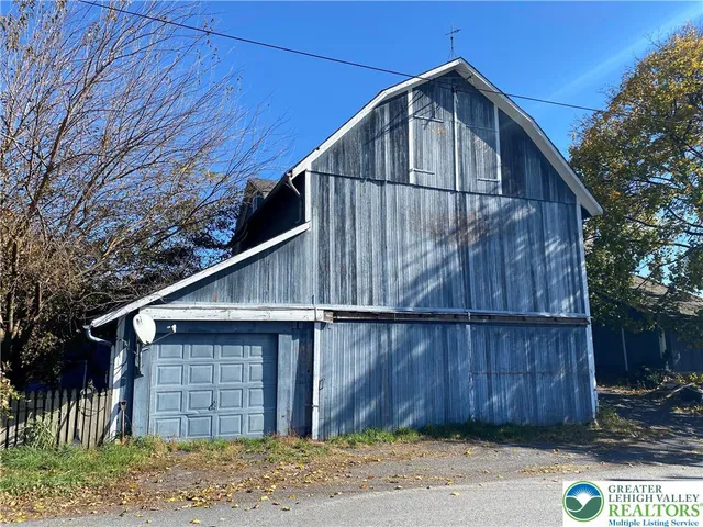 a wooden house with a large window in back yard