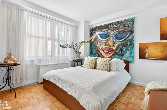 a bedroom with a bed and a window