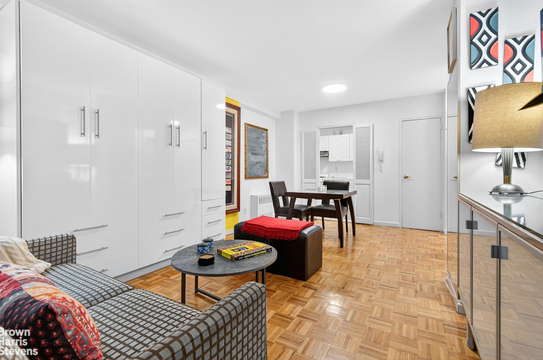 520 East 72nd Street, Unit 3R Manhattan, NY 10021 - Photo 4 of 16 a living room with furniture and a flat screen tv