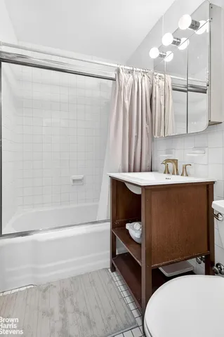 a bathroom with a sink toilet and shower