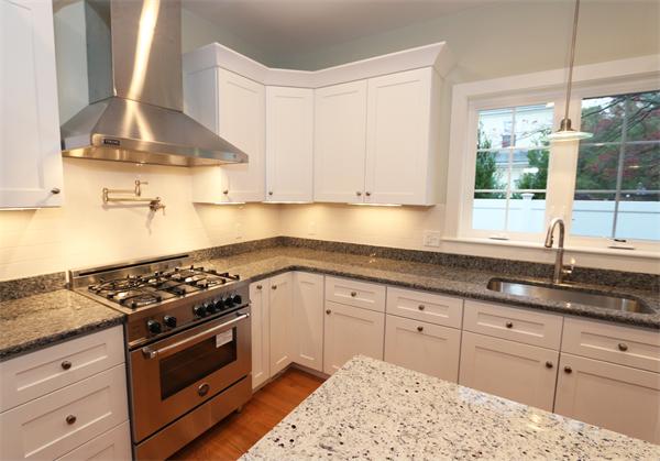 59 Kilburn Road Newton, MA 02465 - Photo 3 of 21 a kitchen with granite countertop white cabinets and white appliances
