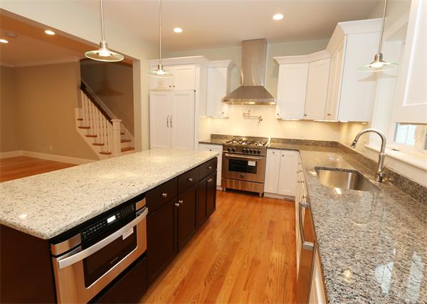 59 Kilburn Road Newton, MA 02465 - Photo 4 of 21 a kitchen with stainless steel appliances granite countertop a stove a sink and a microwave