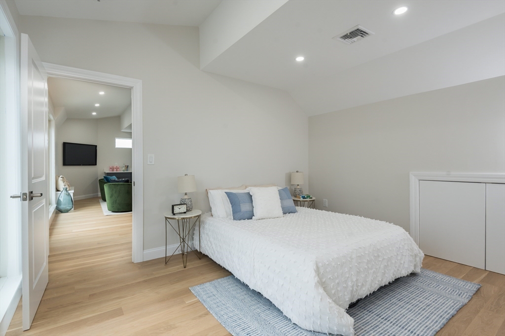 6 Gordon Road, Unit 6 Arlington, MA 02474 - Photo 34 of 40 a bedroom with a bed and a large mirror