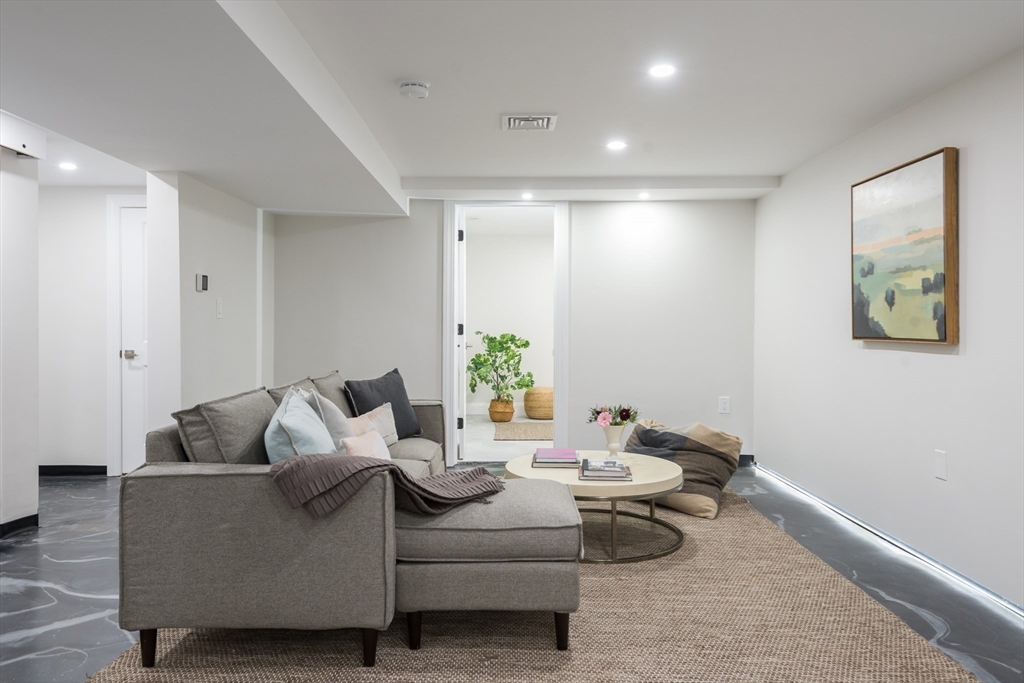 6 Gordon Road, Unit 6 Arlington, MA 02474 - Photo 35 of 40 a living room with furniture and a potted plant