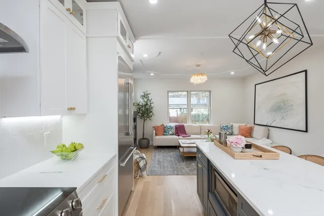 a living room with furniture and a chandelier