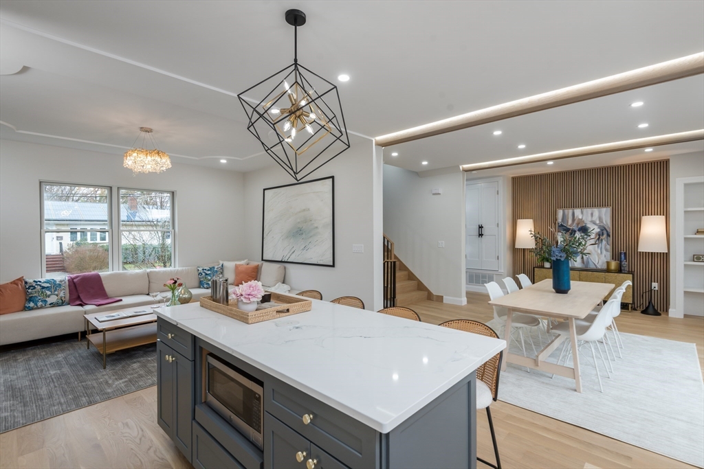 6 Gordon Road, Unit 6 Arlington, MA 02474 - Photo 7 of 40 a view of a dining room and livingroom with furniture wooden floor a chandelier