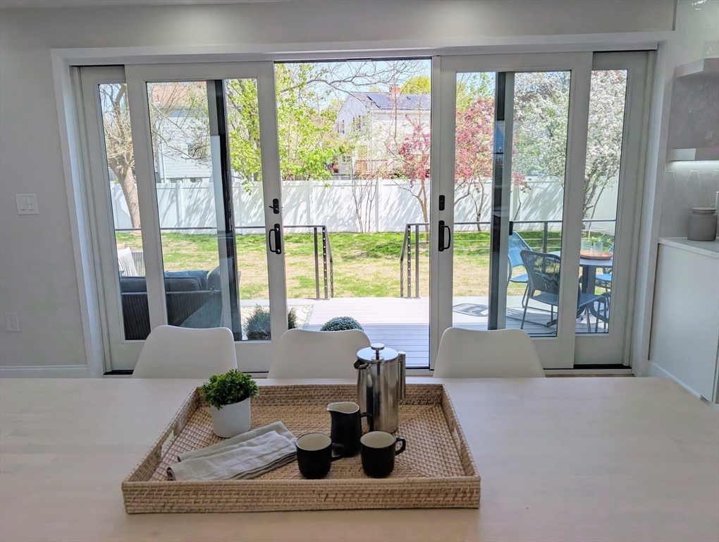6 Gordon Road, Unit 6 Arlington, MA 02474 - Photo 10 of 40 a living room with large windows with table