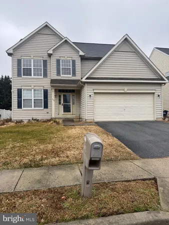 a front view of a house with garage